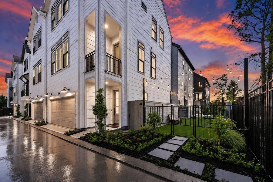 Beautiful exterior view with private green space and evening curb appeal Beautiful exterior view with private green space and evening curb appeal