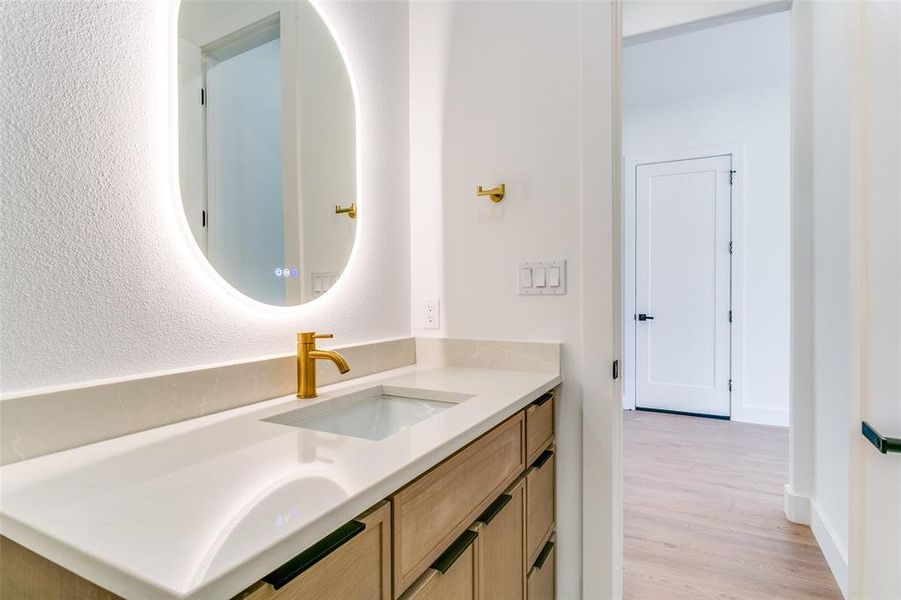 Bathroom with vanity and wood finished floors Bathroom with vanity and wood finished floors