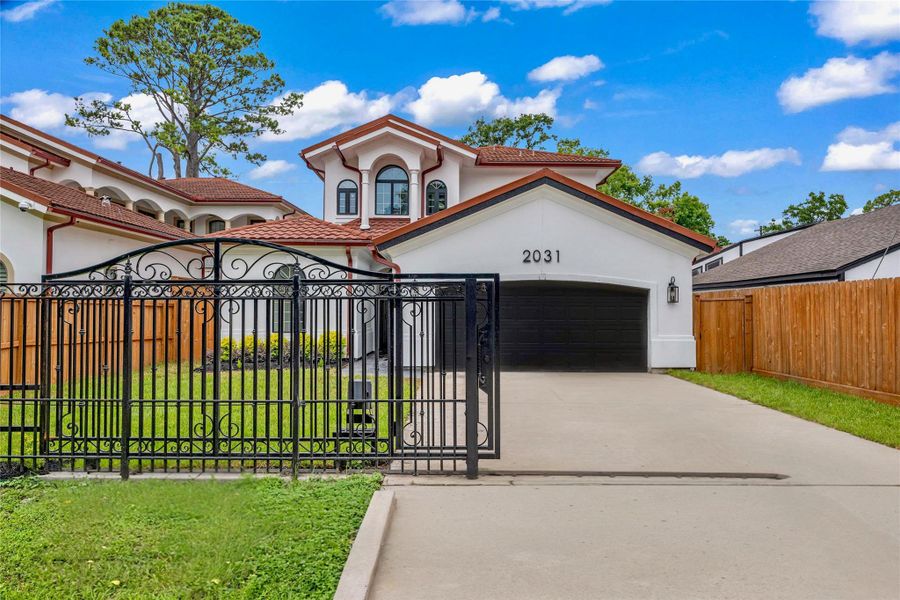 Property features a remote-access wrought iron gate for added privacy and security. Property features a remote-access wrought iron gate for added privacy and security.