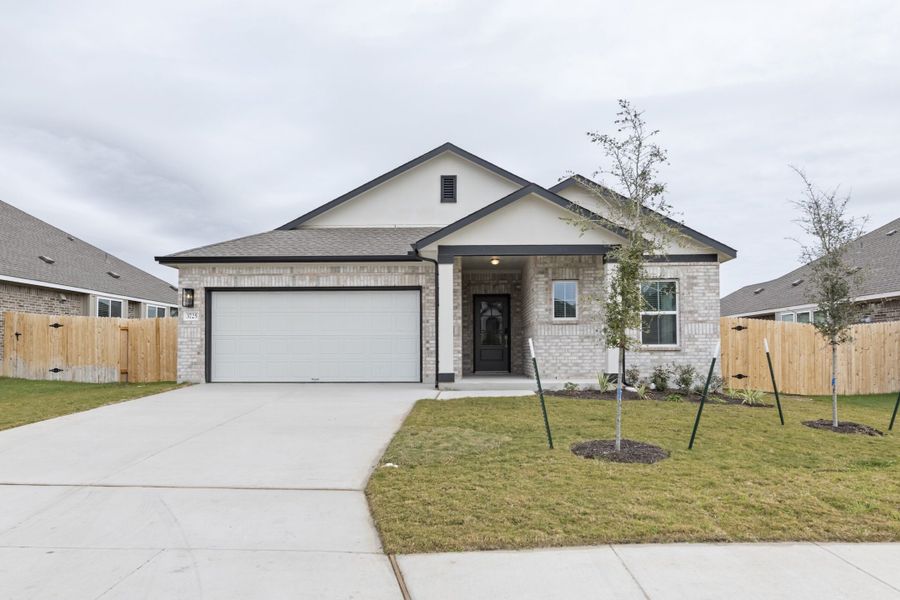 Front exterior of a new home in Village at Three Oaks, Seguin, TX, highlighting curb appeal (Image 26).
