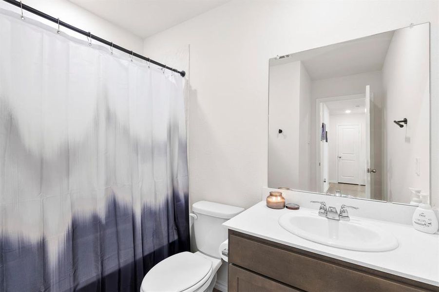 Bathroom featuring vanity and toilet Bathroom featuring vanity and toilet