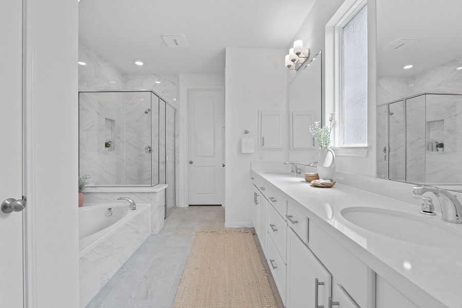 Full bath with a bath, a marble finish shower, double vanity, and recessed lighting