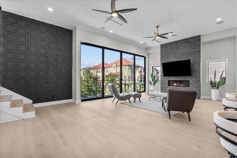 This modern living room features large floor-to-ceiling windows with a scenic view, a sleek fireplace, and stylish furnishings. The space is bright with light wood flooring, a textured accent wall, and ceiling fans, offering a blend of comfort and elegance. This modern living room features large floor-to-ceiling windows with a scenic view, a sleek fireplace, and stylish furnishings. The space is bright with light wood flooring, a textured accent wall, and ceiling fans, offering a blend of comfort and elegance.