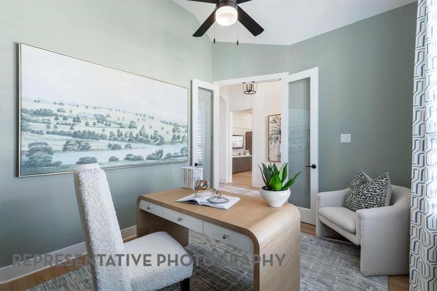 Office space with wood finished floors, a ceiling fan, and lofted ceiling