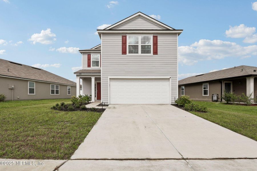 Front exterior of a new home in Cross Creek Express, Green Cove Springs, FL, highlighting curb appeal (Image 22).