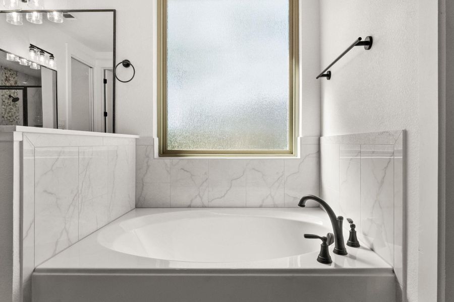 Full bathroom with a garden tub and a shower stall