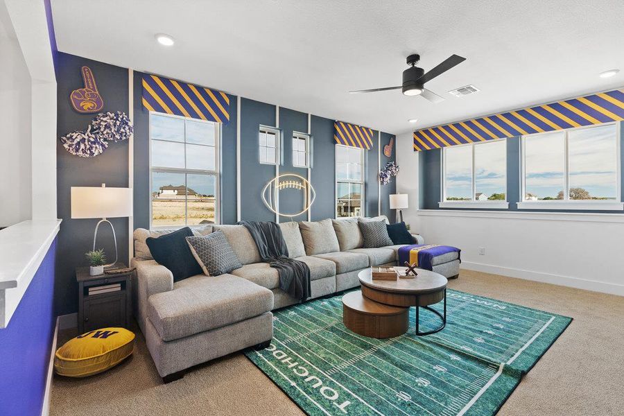 Carpeted living room with a ceiling fan and recessed lighting