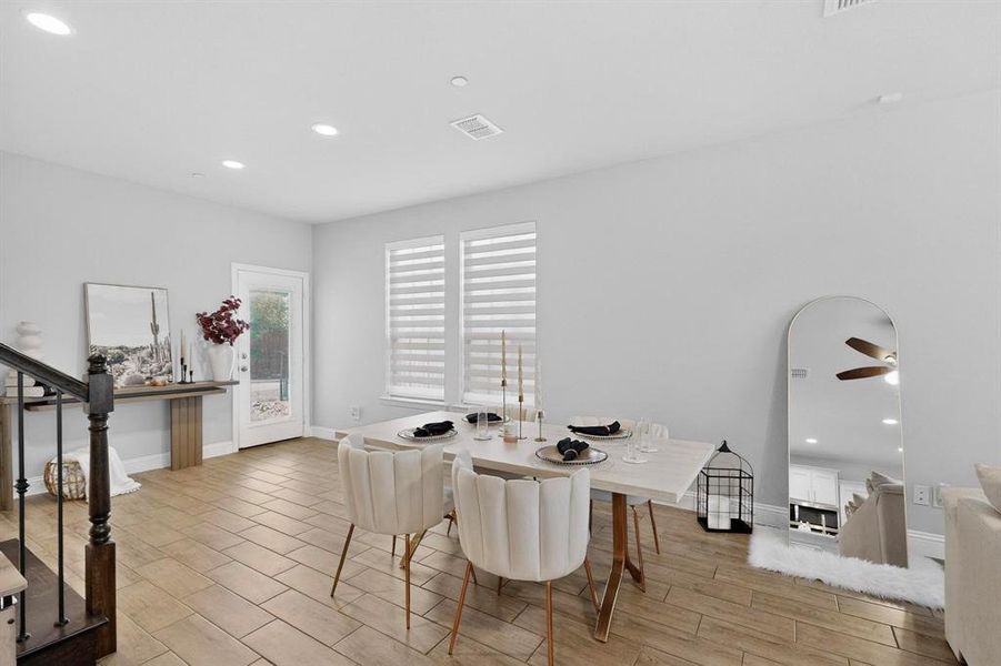 The property features an open-concept dining area with large windows providing natural light, recessed lighting, and tile flooring