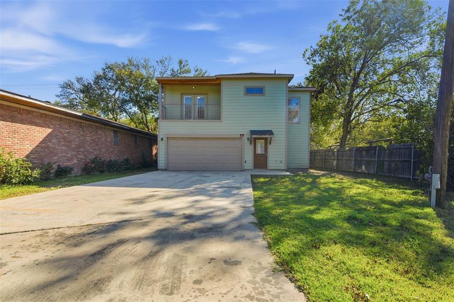 View of front of home with a balcony, driveway, and an attached garage View of front of home with a balcony, driveway, and an attached garage