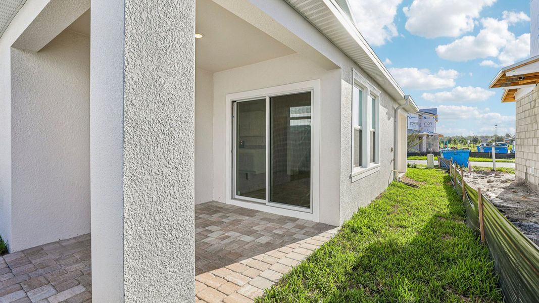 Exterior details and patio area of a home in Cyrene at Harmony, St. Cloud (Image 20).
