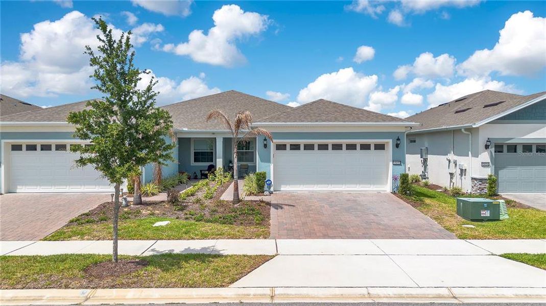 Front exterior of a new home in Del Webb Oasis, Winter Garden, FL, highlighting curb appeal (Image 23).