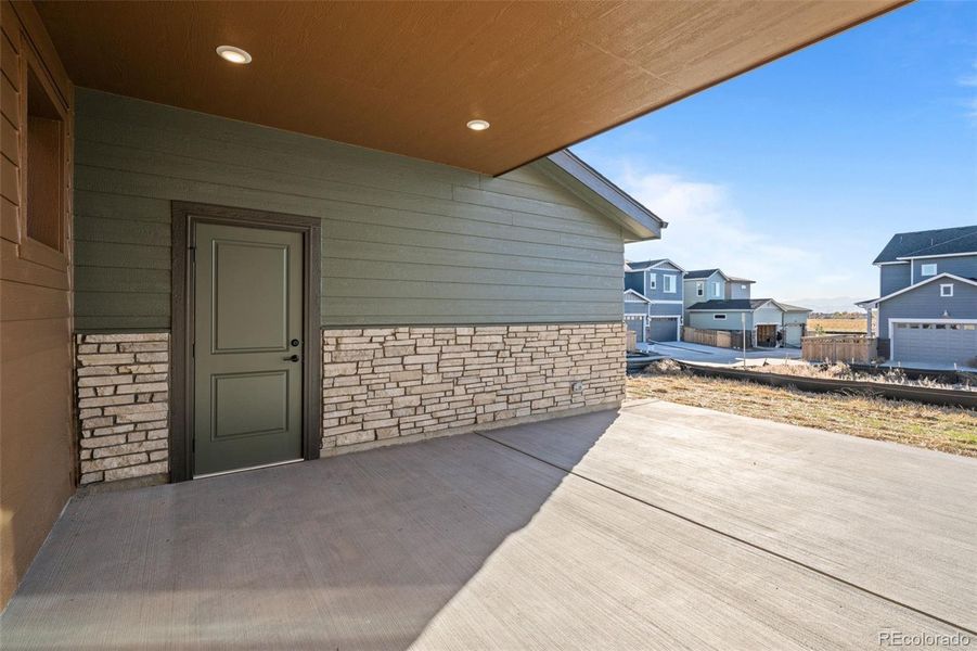 Exterior details and patio area of a home in Painted Prairie, Aurora (Image 27).