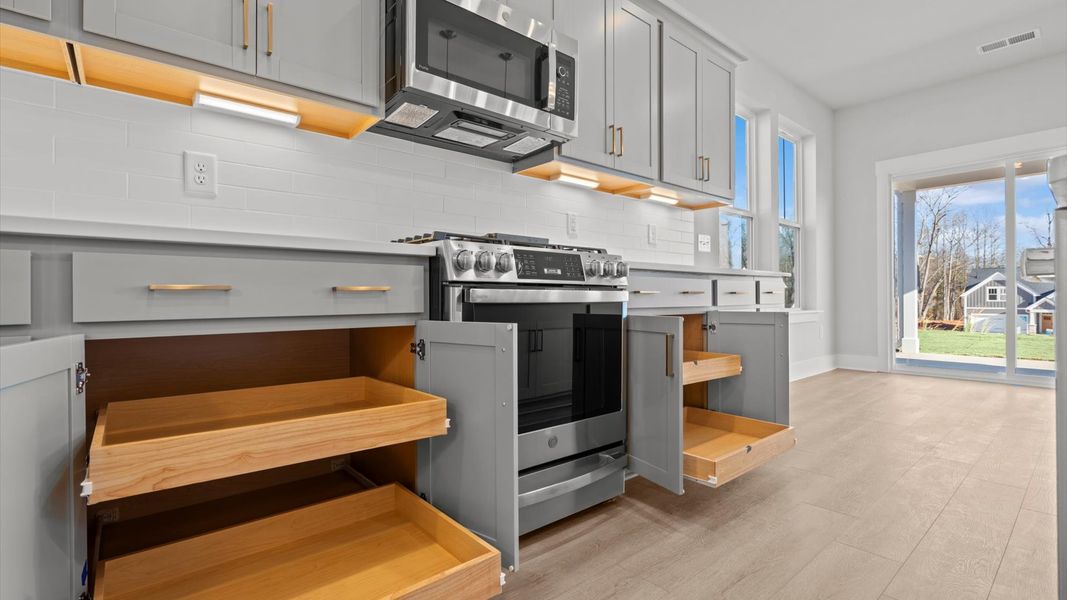 Exclusive DRB Homes kitchen with a 7-foot island, elevated finishes, and pendant lighting in a prime location