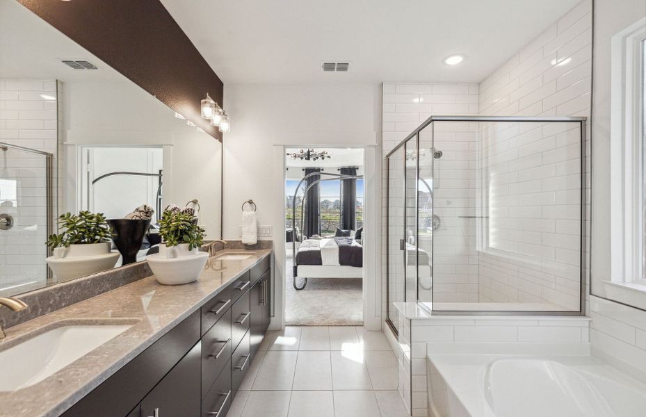 Owner's bath with large tub and shower