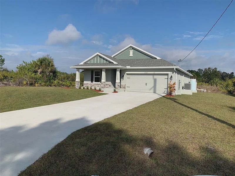 Front exterior of a new home in Gulf Cove, Port Charlotte, FL, highlighting curb appeal (Image 2). Front exterior of a new home in Gulf Cove, Port Charlotte, FL, highlighting curb appeal (Image 2).