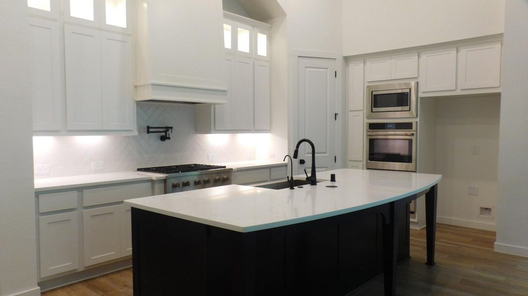 Kitchen with Island and Bar Seating. Lots of Cabinets for Storage.
