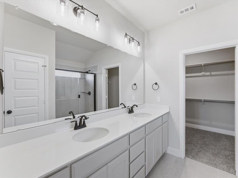 Bathroom featuring a dual vanity with white countertops, undermount sinks, and matte black fixtures Bathroom featuring a dual vanity with white countertops, undermount sinks, and matte black fixtures