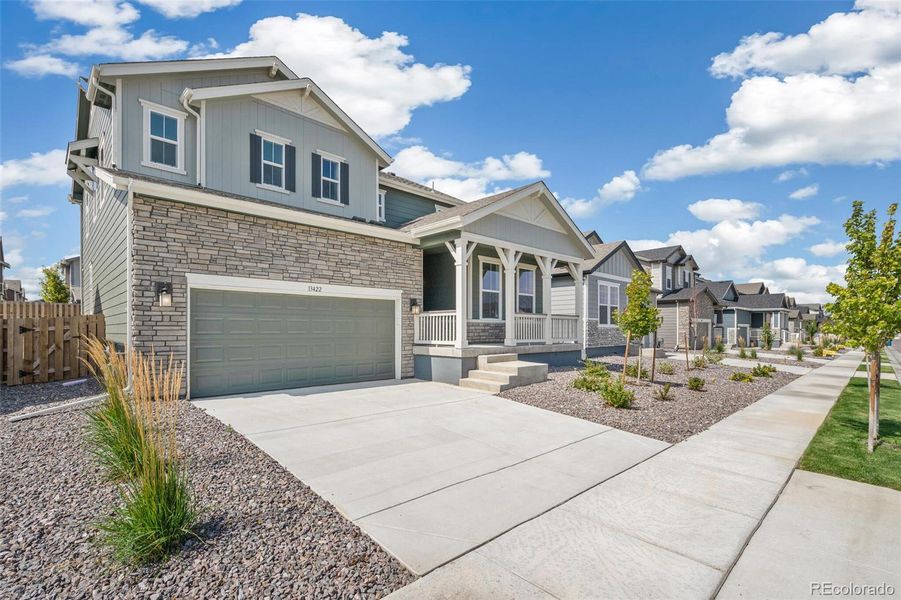 Front exterior of a new home in Turnberry, Commerce City, CO, highlighting curb appeal (Image 19).