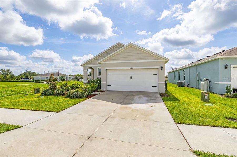 Front exterior of a new home in Bradbury Creek, Haines City, FL, highlighting curb appeal (Image 1). Front exterior of a new home in Bradbury Creek, Haines City, FL, highlighting curb appeal (Image 1).