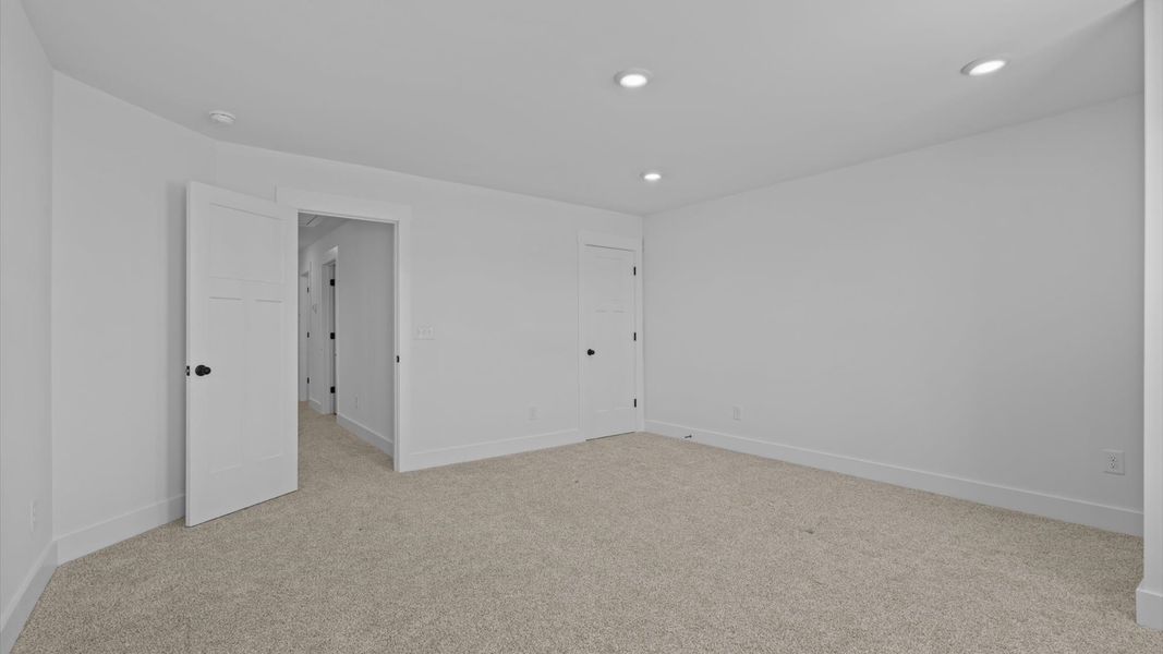 Accomplished design in this restful bedroom featuring plush carpet and oversized window views