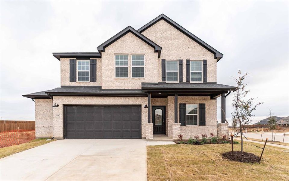 Front exterior of a new home in Sagebrook, Lantana, TX, highlighting curb appeal (Image 1).