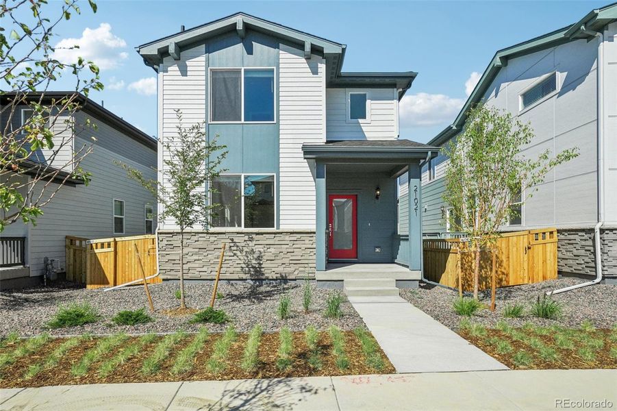 Front exterior of a new home in Woodrose at Painted Prairie, Aurora, CO, highlighting curb appeal (Image 24).