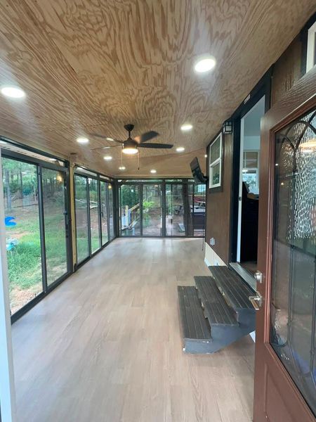 An enclosed patio with extensive glazing brings the outdoors in, perfect for year-round enjoyment.