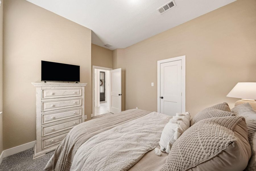 Another view of the third bedroom with the spacious walk-in closet to the right which provides plenty of storage for a beautifully organized retreat.