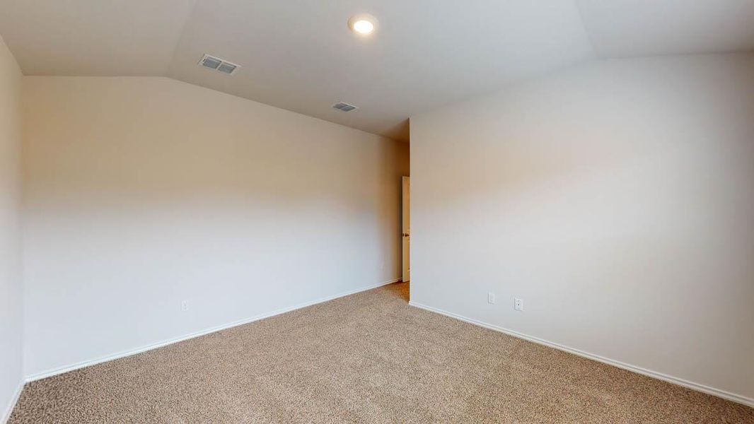 Carpeted interior space with vaulted ceilings, recessed lighting, base molding, and warm neutral wall tones