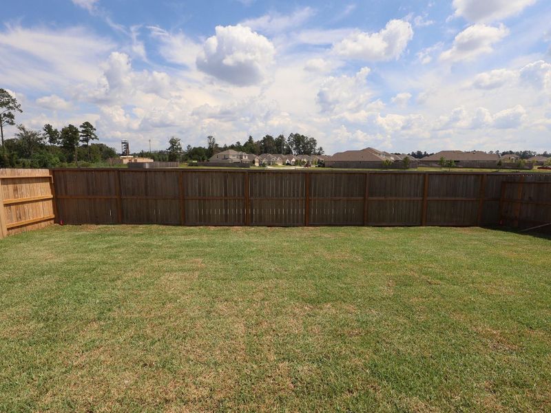 Front exterior of a new home in Pinewood at Grand Texas, New Caney, TX, highlighting curb appeal (Image 13). Front exterior of a new home in Pinewood at Grand Texas, New Caney, TX, highlighting curb appeal (Image 13).