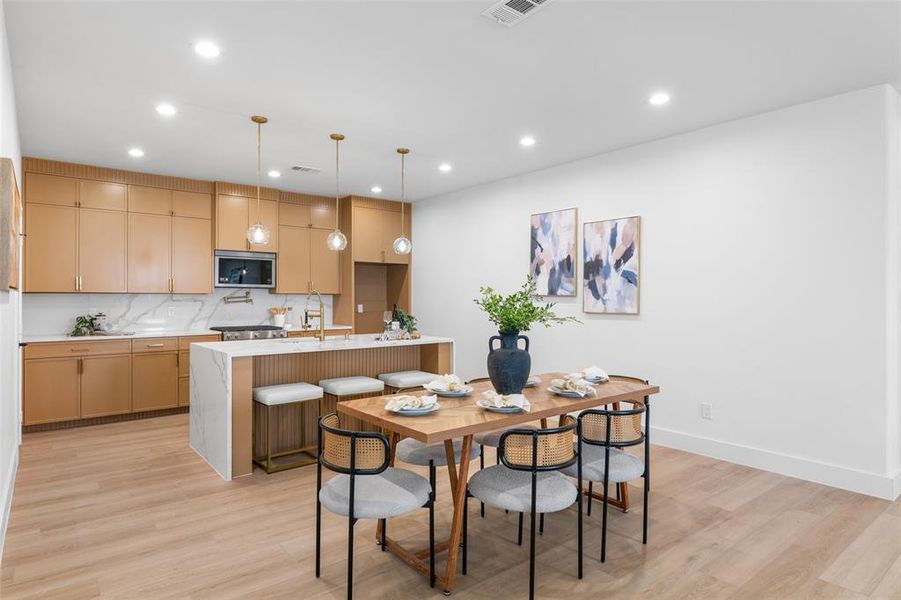 Dining area featuring light wood-style flooring and recessed lighting