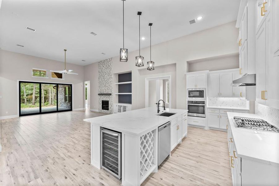 Pendant lights over kitchen island; prewired for surround sound in living area