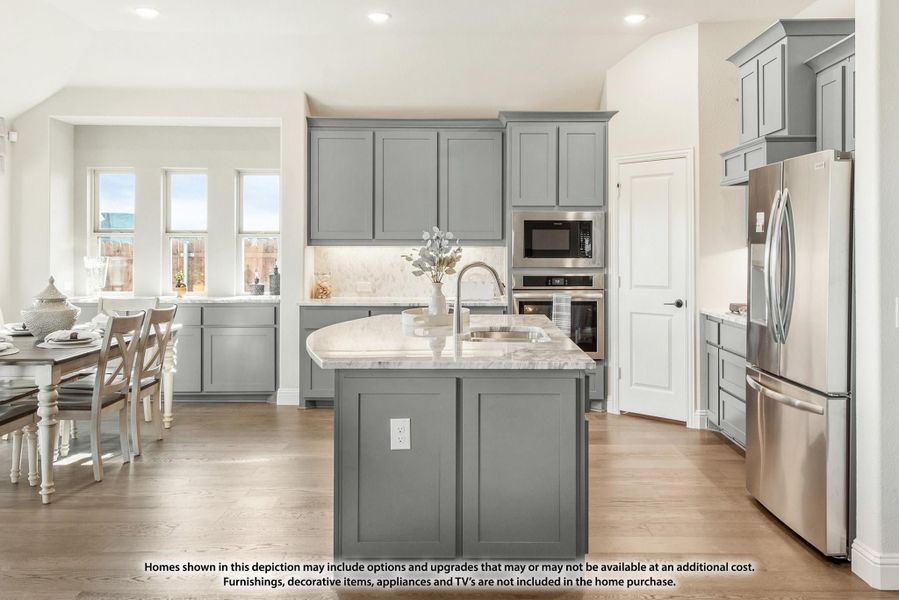 Kitchen with gray cabinets, center island with sink, stainless steel appliances, and hardwood floors open to dining area. Kitchen with gray cabinets, center island with sink, stainless steel appliances, and hardwood floors open to dining area.