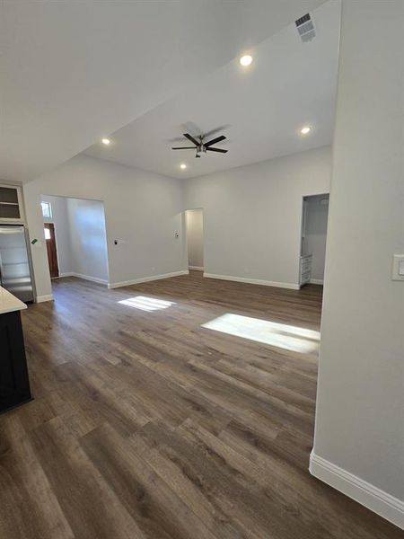 Unfurnished living room with ceiling fan and hardwood / wood-style flooring