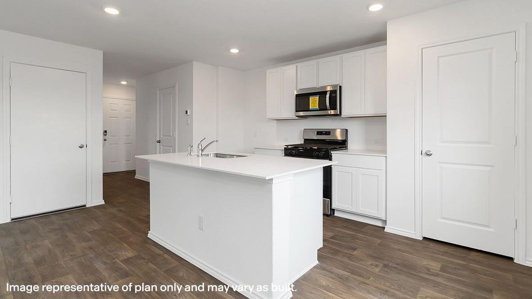 Kitchen featuring stainless steel appliances, white cabinets, dark wood finished floors, a center island with sink, and recessed lighting