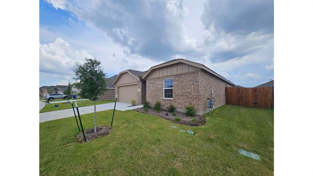Brick exterior with contrasting horizontal siding details and a two-car garage Brick exterior with contrasting horizontal siding details and a two-car garage