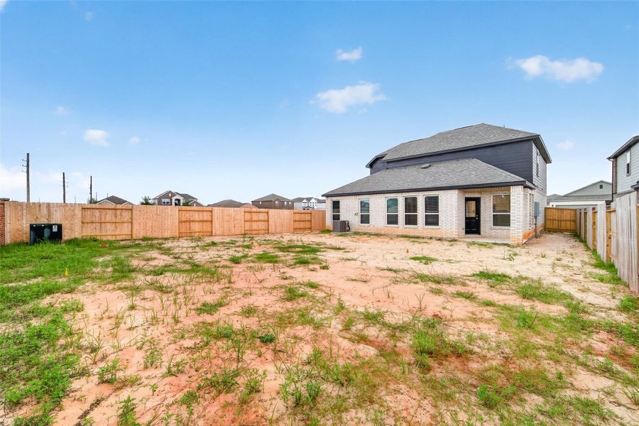 Exterior details and patio area of a home in Sunterra, Katy (Image 28).