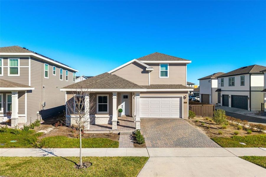 Front exterior of a new home in Weslyn Park at Sunbridge, St. Cloud, FL, highlighting curb appeal (Image 28).
