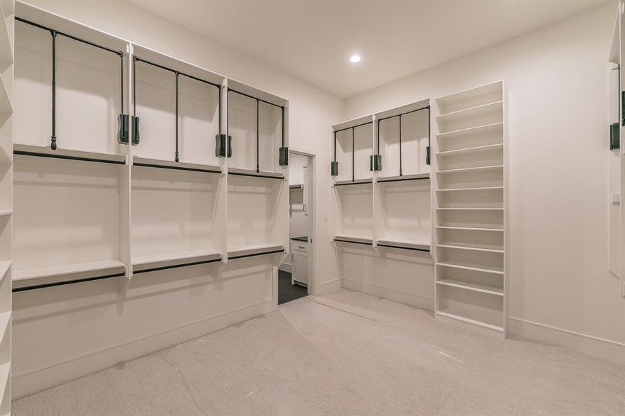 Spacious closet with light colored carpet