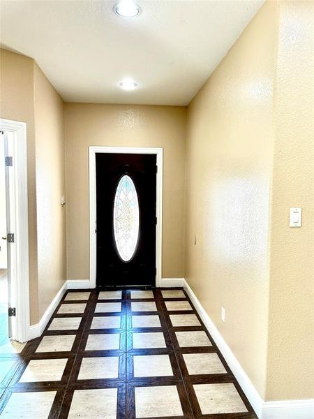 Entrance foyer featuring dark tile patterned flooring