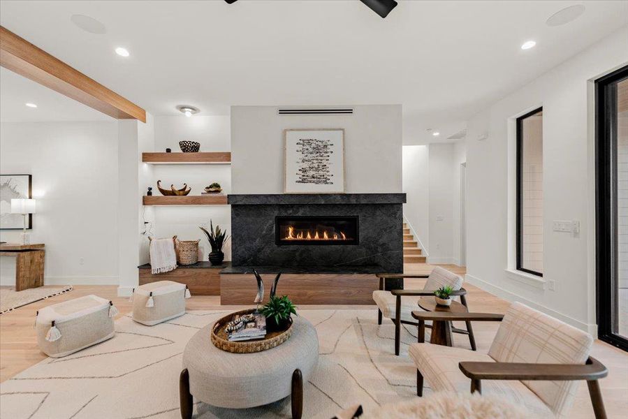 Soap stone fireplace and mantle  and adjacent floating shelves.  Two options for TV mounting location.
