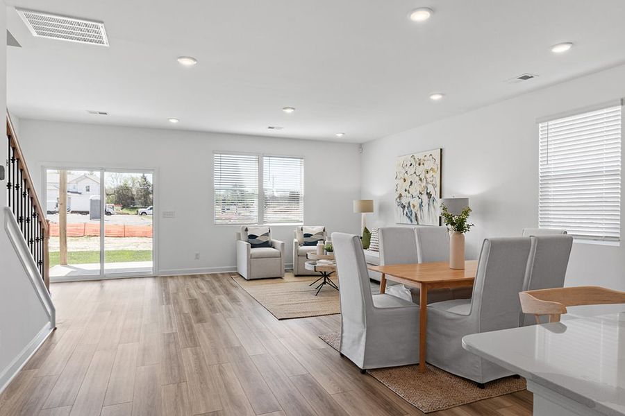 A room with a table chairs and a window.