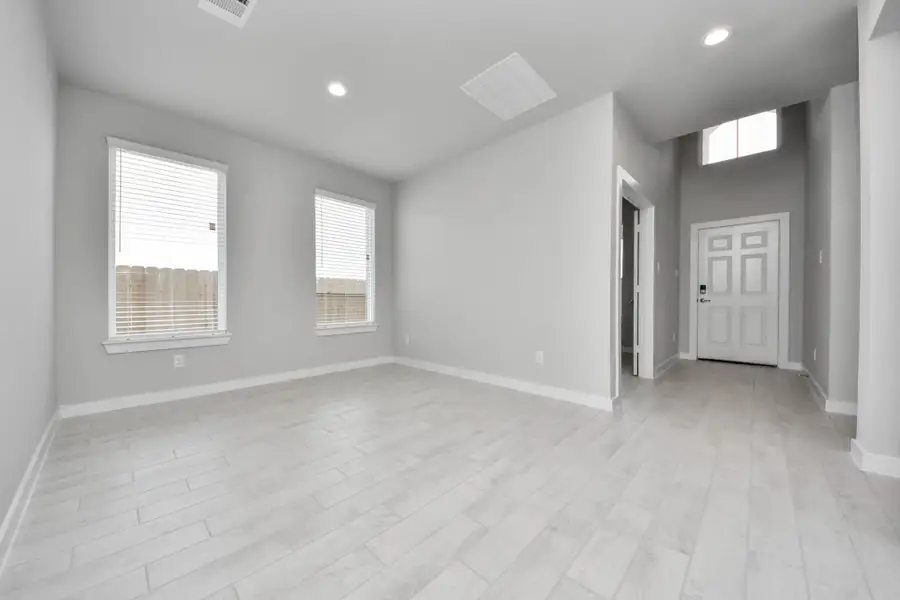 Make memories gathered around the table with your family and friends! This spacious dining room features elegant flooring, custom paint, and adjacent to family room and kitchen for open concept feel. Sample photo of completed home with similar floor plan. Actual colors and selections may vary.
