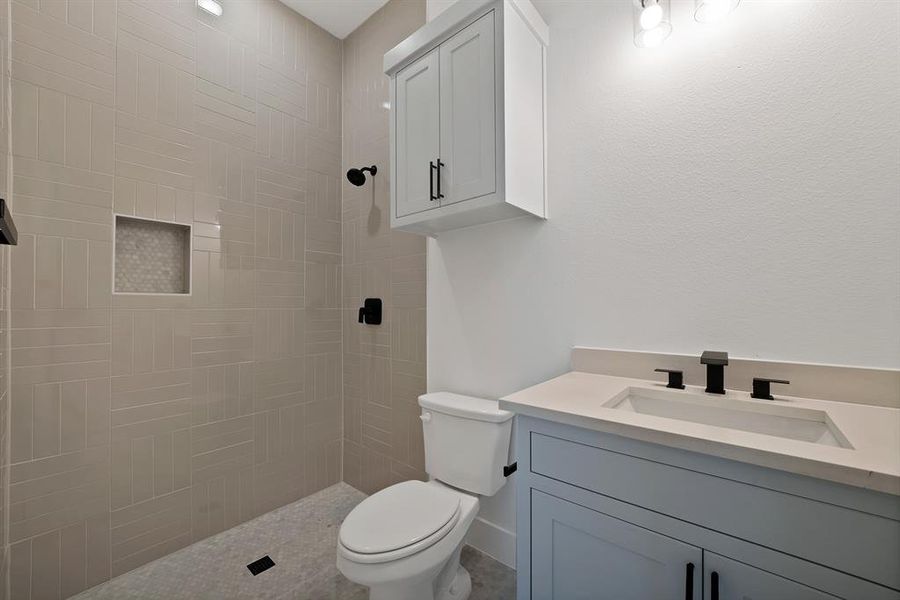 Bathroom featuring vanity and a tile shower Bathroom featuring vanity and a tile shower
