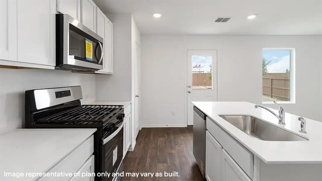 Kitchen featuring stainless steel appliances, white cabinets, dark wood-style floors, light stone countertops, and recessed lighting