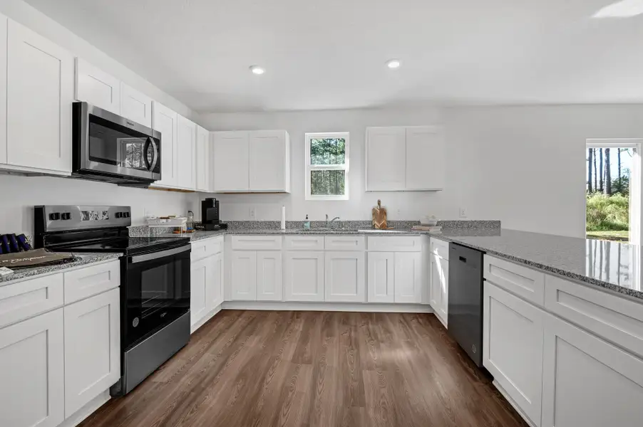 A kitchen with white cabinets.
