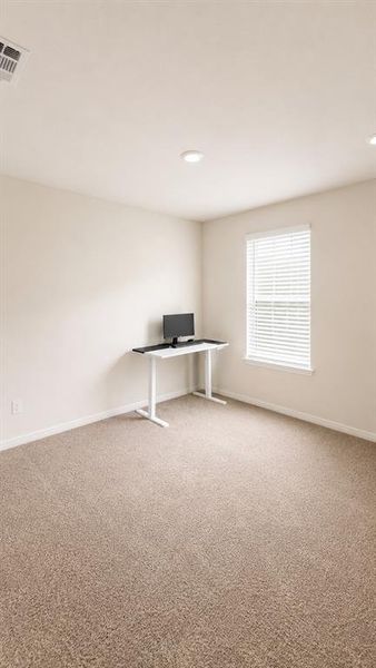 Room featuring neutral-toned carpeting, light-colored walls, and a single window with horizontal blinds Room featuring neutral-toned carpeting, light-colored walls, and a single window with horizontal blinds