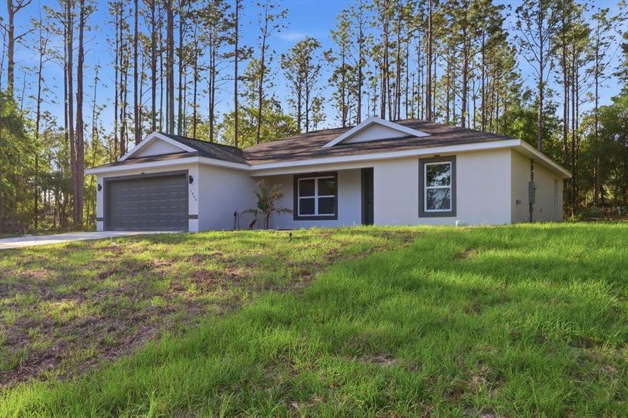 Front exterior of a new home in , Citrus Springs, FL, highlighting curb appeal (Image 25).