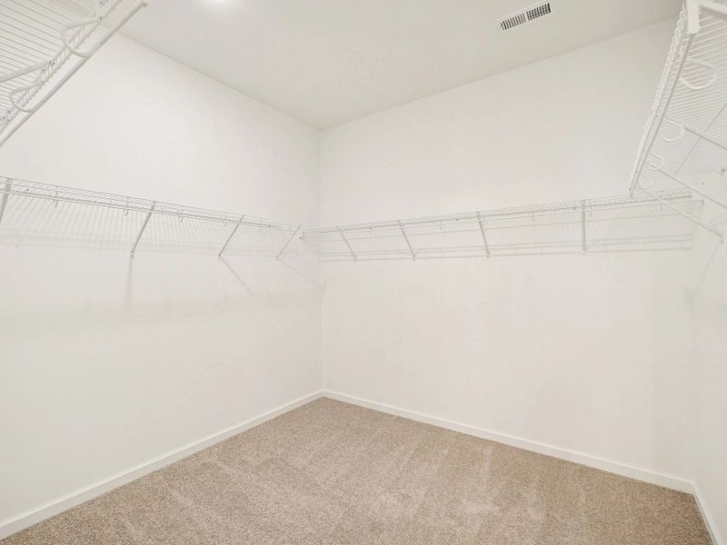 Primary Walk-In featuring the AW Collection® Serene - Open storage with understated design.