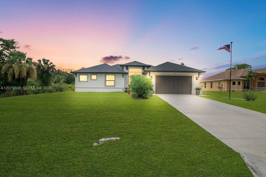 Front exterior of a new home in , Lehigh Acres, FL, highlighting curb appeal (Image 24). Front exterior of a new home in , Lehigh Acres, FL, highlighting curb appeal (Image 24).